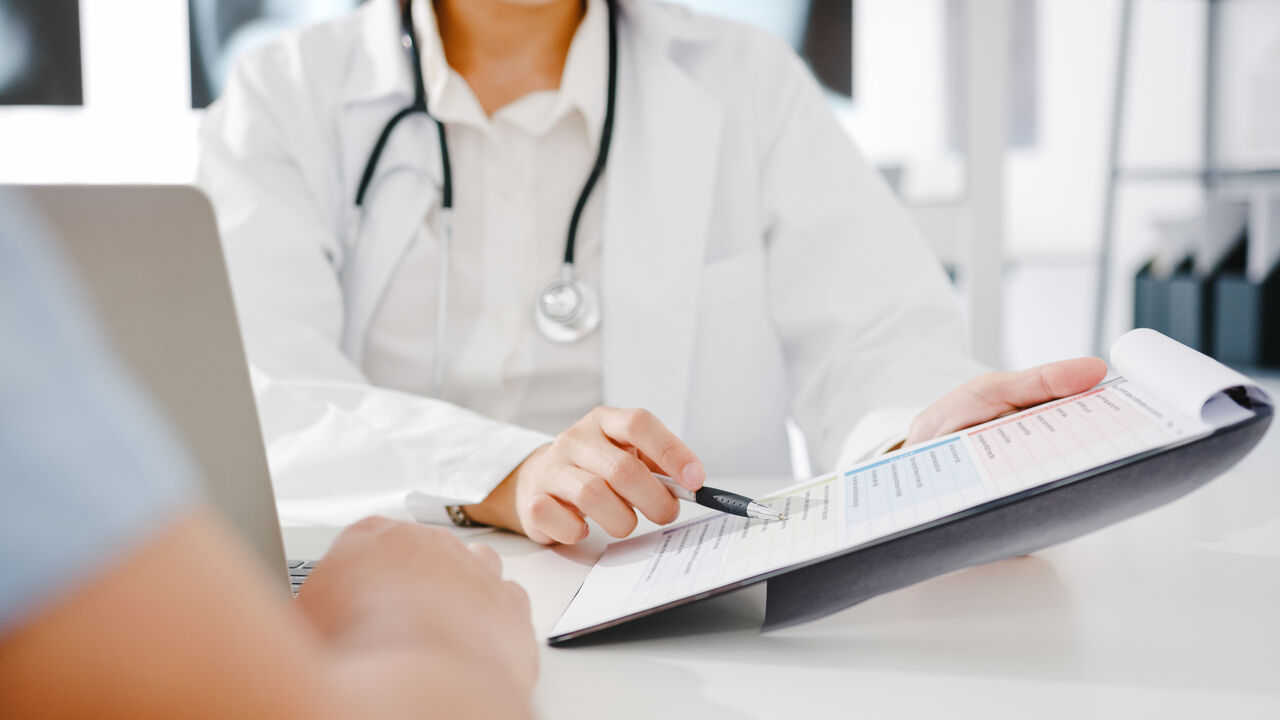Dr pointing pen at checklist